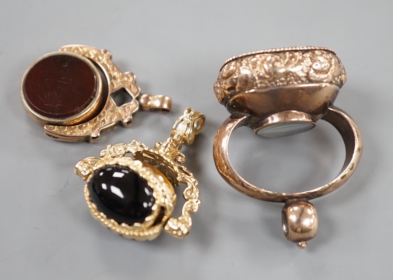 A late 19th/early 20th century yellow metal overlaid and foil backed rock crystal set fob seal with inset compass, 37mm and two other later hardstone set fob seals.
